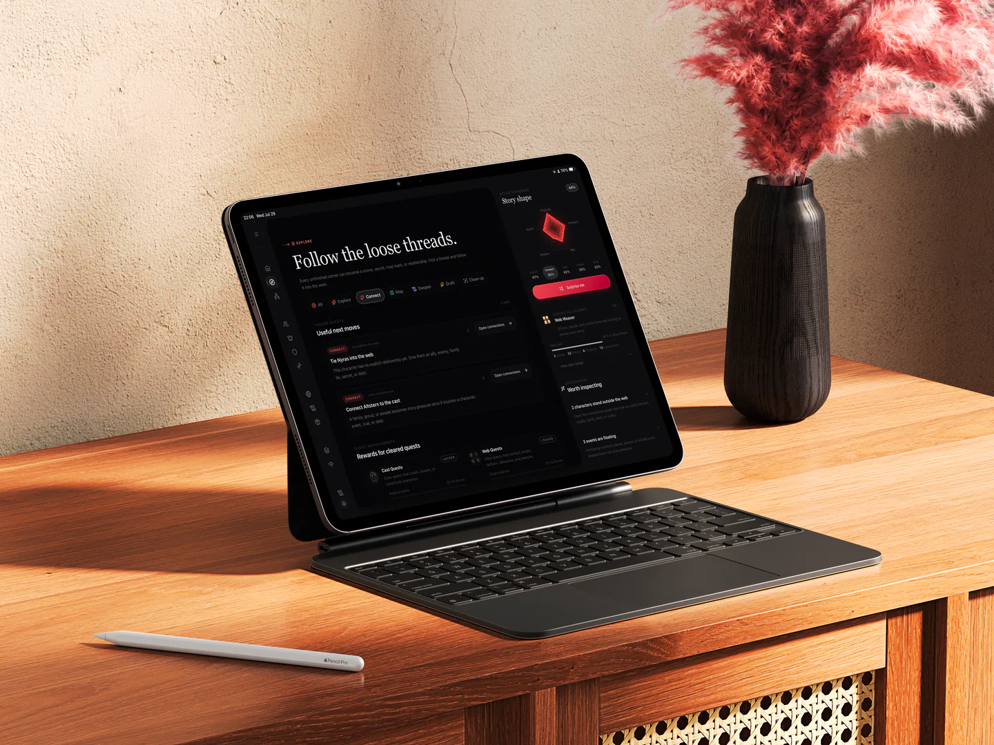 RedThread running on an iPad with Magic Keyboard on a sunlit wooden desk beside a vase of red foliage